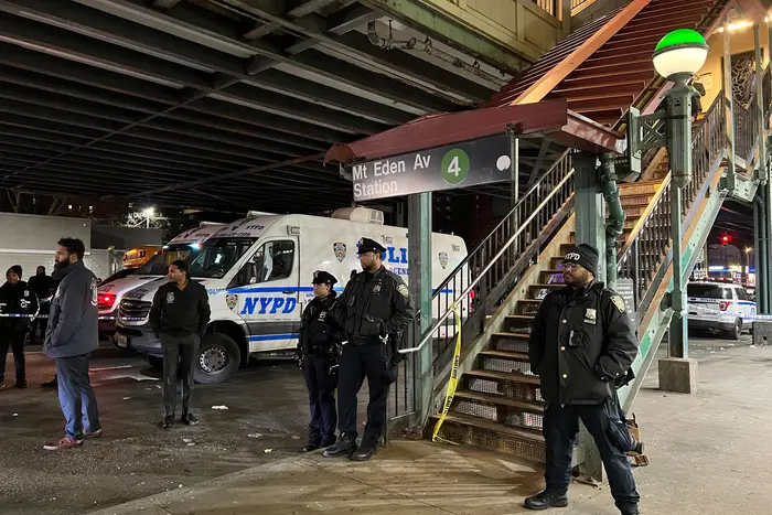 Officers stand near the entrance to the Bronx subway platform where a shooting occurred on Monday afternoon.